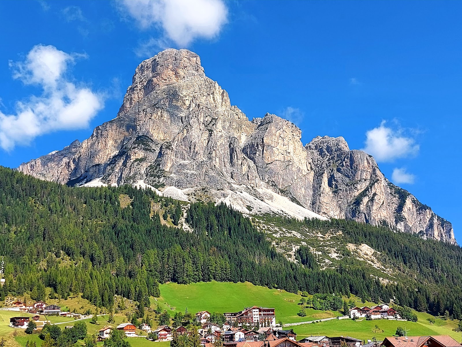 Wide sunny groomed pistes in Alta Badia below the Dolomite peaks