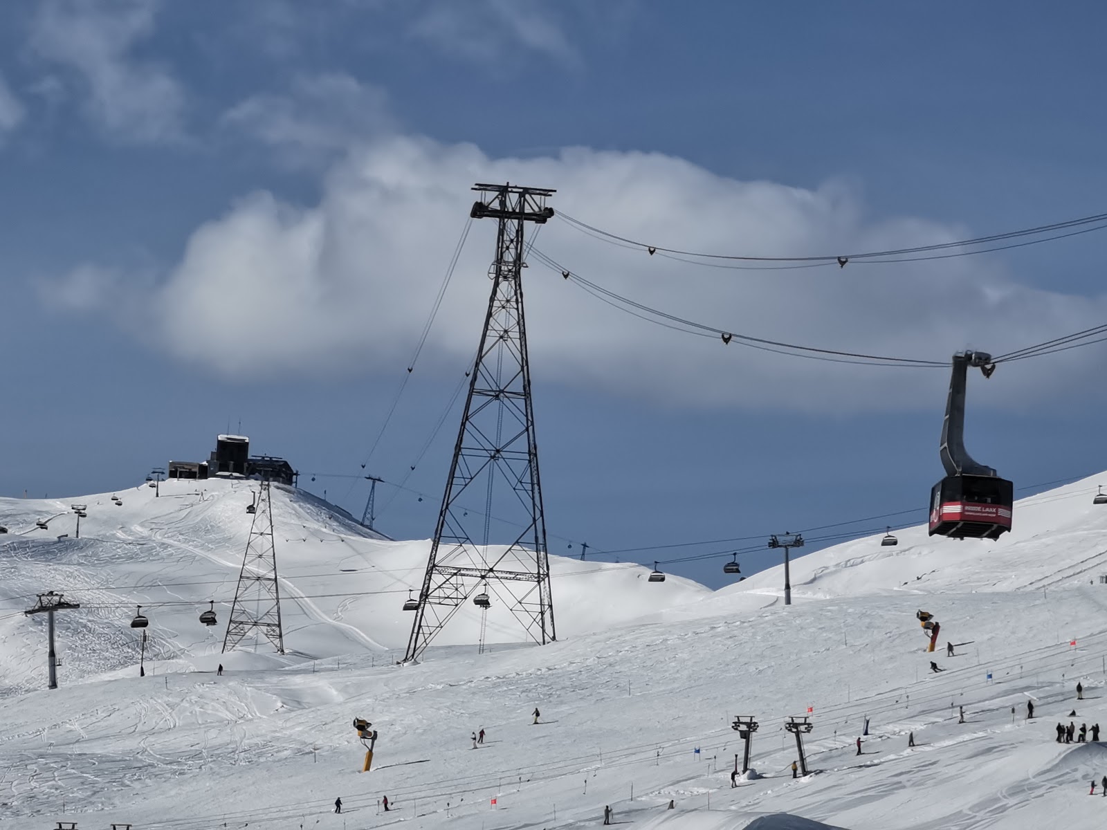 A snowboarder hitting a jump in the snowpark at Laax