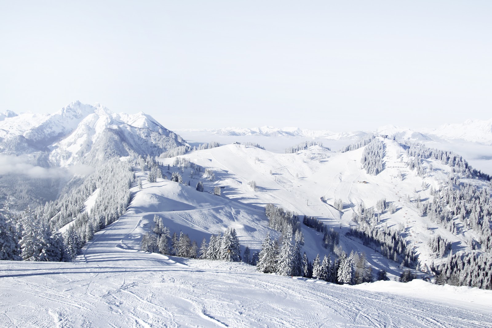 Well groomed Snow Space Salzburg pistes above St Johann im Pongau in sunshine