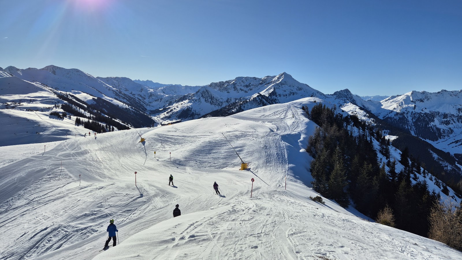 Gondola rising toward the Schatzberg over snowy meadows