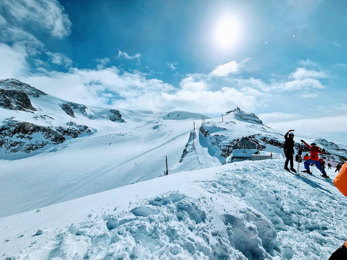 Skiers on a glacier run high above Zermatt